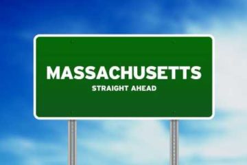 Green road sign reading Massachusetts Straight Ahead
