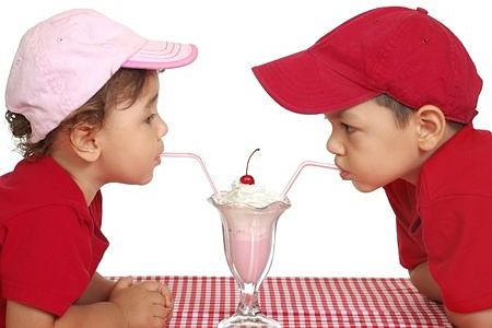 Young boys sharing a strawberry sundae
