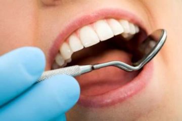 dental mirror inside patient's open mouth