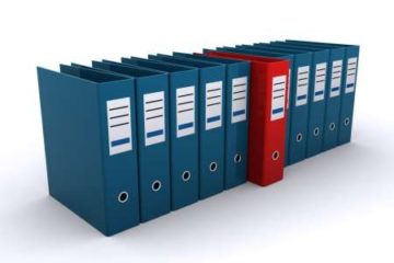 row of blue binders with one red binder sticking out