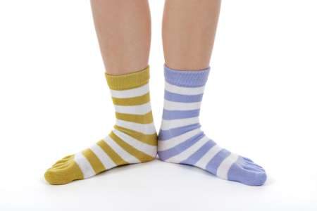 feet wearing different colored striped socks