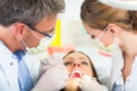 Dentist and assistant treating patient