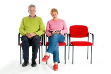 couple waiting while sitting in chairs