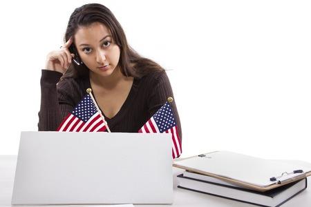 federal employee sitting in front of laptop with American Flags