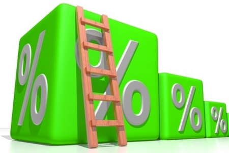 Ladder leaning against large green dice with percentage signs