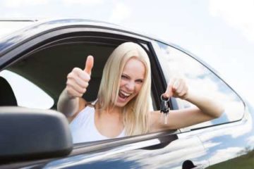 happy woman in car after her purchase