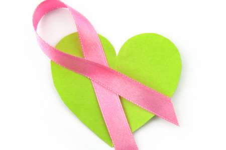 Green heart with pink ribbon honoring breast cancer victims