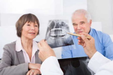 Elderly couple viewing dental X-ray