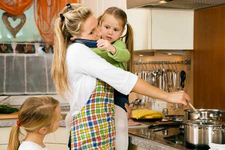 homemaker cooking meal, talking on phone while holding child