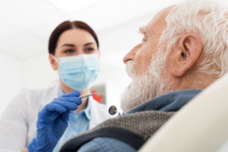 Medicare dentist treating senior citizen