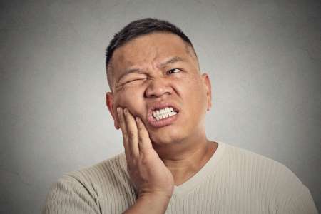 man with painful toothache